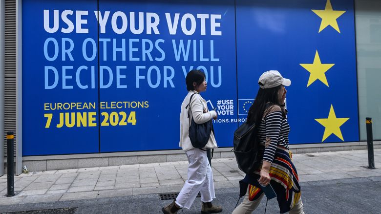 DUBLIN, IRELAND - MAY 21: 
Two passersby walk in front of the 'Europa Experience' visitor center in Dublin, which is advertising the European Parliament election on June 7, on May 21, 2024, in ublin Ireland. (Photo by Artur Widak/NurPhoto via Getty Images)