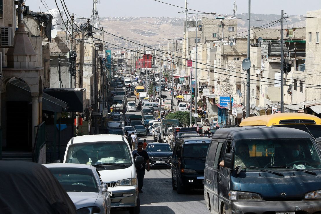 Cars drive along a street in the Palestinian refugee camp of Baqa'a near Amman, Jordan in May 2024.