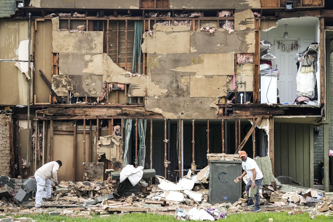 HOUSTON, TEXAS - MAY 17: Crews work to clean up debris after a wall came down in the aftermath of a severe storm on Friday, May 17, 2024 in Houston. Fast-moving thunderstorms pummeled southeastern Texas for the second time this month, killing at least four people, blowing out windows in high-rise buildings, downing trees and knocking out power to more than 900,000 homes and businesses in the Houston area. (Brett Coomer/Houston Chronicle via Getty Images)