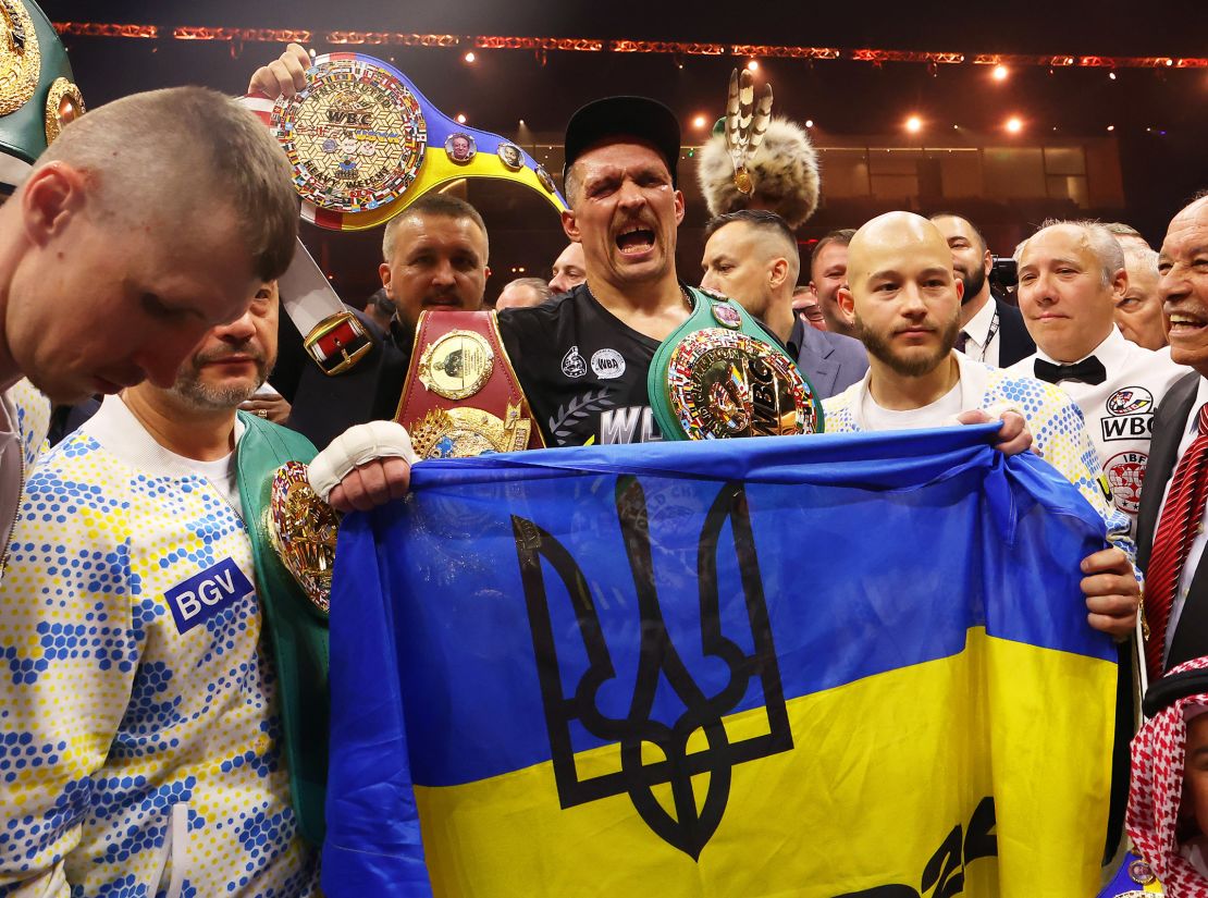 Oleksandr Usyk holds a Ukrainian flag as he celebrates with the Undisputed Heavyweight title belt following his victory over Tyson Fury on May 18, 2024.