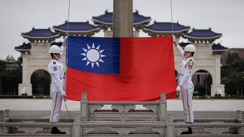 Honour guards raise Taiwan's flag on Democracy Boulevard at Chiang Kai-shek Memorial Hall in Taipei on May 23, 2024.