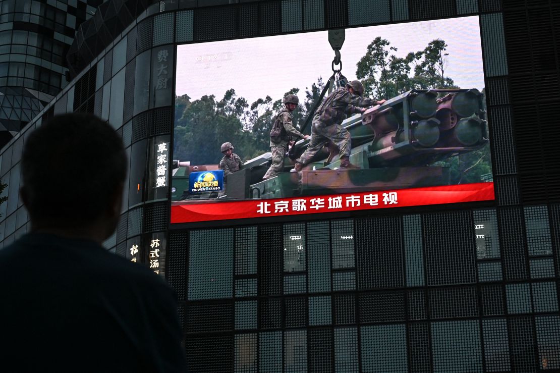 An outdoor screen in Beijing shows footage of Chinese military drills around Taiwan.