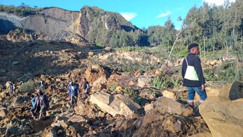 People gather at the site of a landslide in Maip Mulitaka in Papua New Guinea's Enga Province on May 24, 2024. Local officials and aid groups said a massive landslide struck a village in Papua New Guinea's highlands on May 24, with many feared dead.