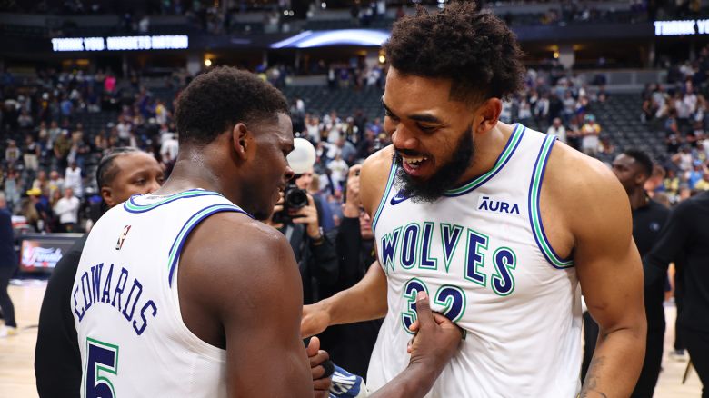Karl-Anthony Towns #32 and Anthony Edwards #5 of the Minnesota Timberwolves react after winning Game Seven of the Western Conference Second Round Playoffs against the Denver Nuggets at Ball Arena on May 19, 2024 in Denver, Colorado.