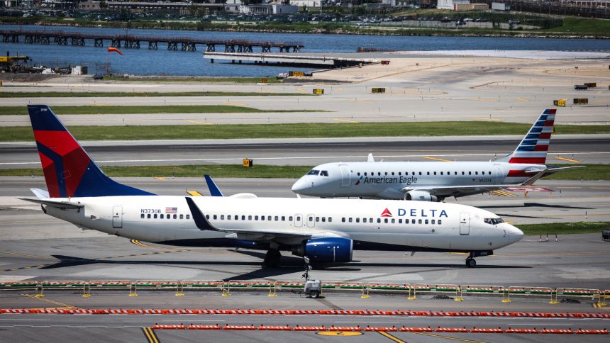 Delta Airlines and American Airlines planes taxi at LaGuardia Airport in Queens, New York.