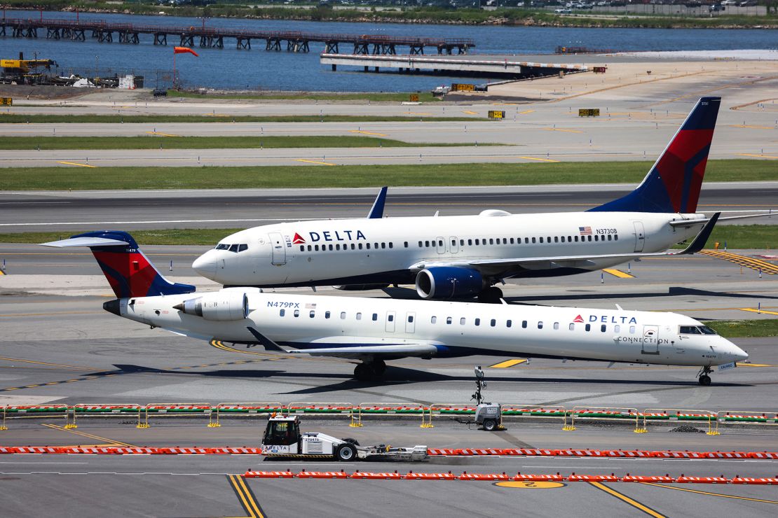 A Delta Airlines' Boeing 737 plane and a Delta Airlines' Bombardier CRJ-900LR plane taxi at LaGuardia Airport in Queens, New York on May 24, 2024. (Photo by Charly TRIBALLEAU / AFP) (Photo by CHARLY TRIBALLEAU/AFP via Getty Images)