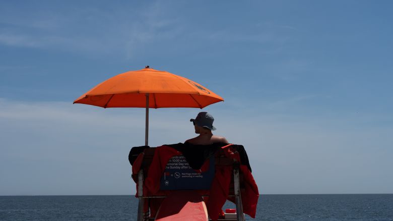 A lifeguard watches over the beach at Coney Island on May 25, 2024 in New York City. New York changed some of its lifeguard requirements to address an ongoing national lifeguard shortage.
