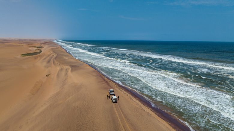 Cars driving on the ridge of the sanddunes along the Atlantic, Namibe (Namib) desert, Iona National Park, Namibe, Angola, Africa