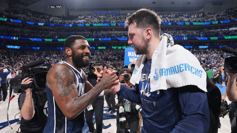 Kyrie Irving #11 and Luka Doncic #77 of the Dallas Mavericks high five during the game against the Minnesota Timberwolves during Game 3 of the Western Conference Finals of the 2024 NBA Playoffs on May 26, 2024 at the American Airlines Center in Dallas, Texas.