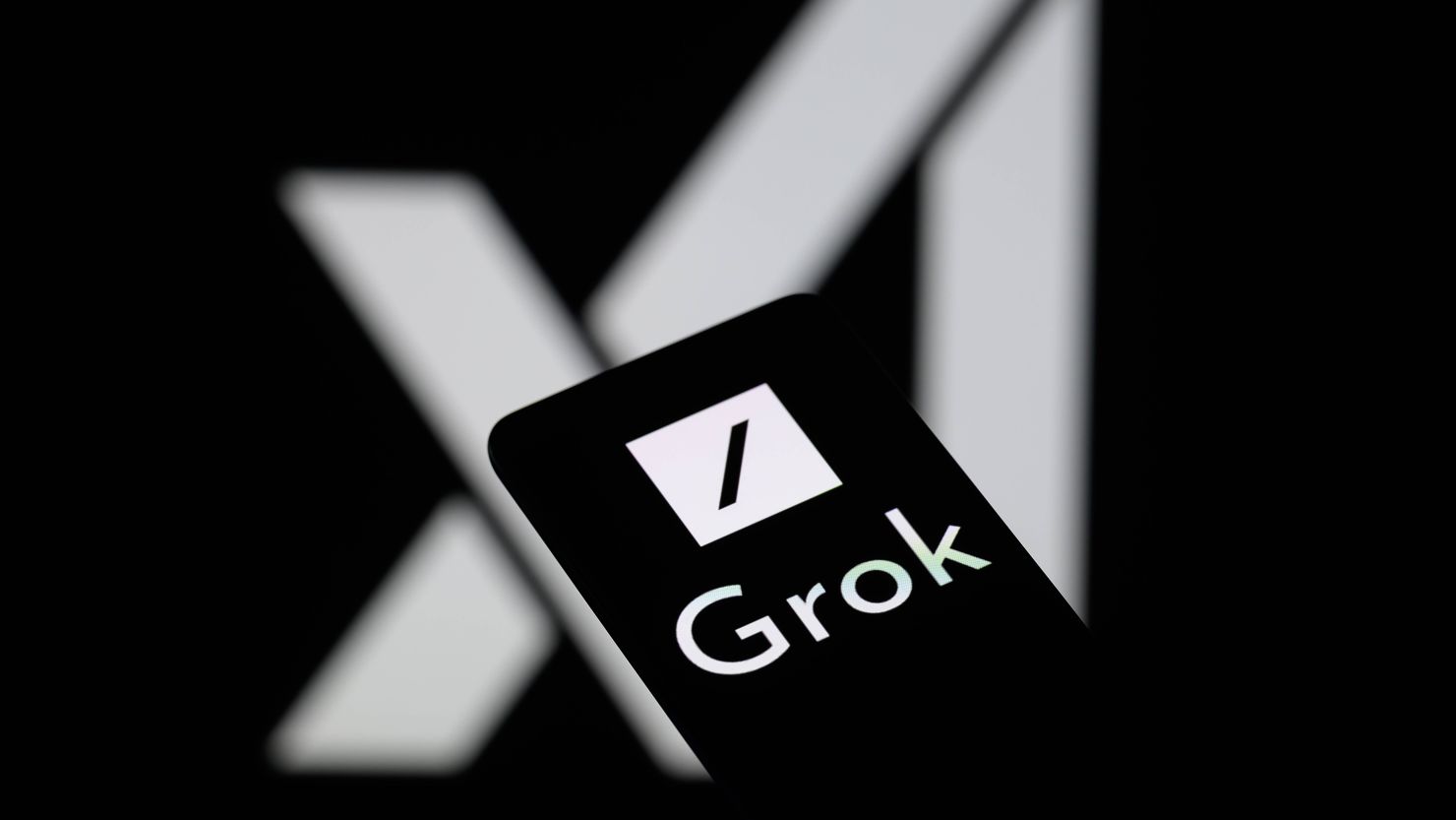 The Grok logo is being displayed on a smartphone with the X AI icon visible in the background in this photo illustration in Brussels, Belgium, on May 27, 2024. (Photo by Jonathan Raa/NurPhoto via Getty Images)