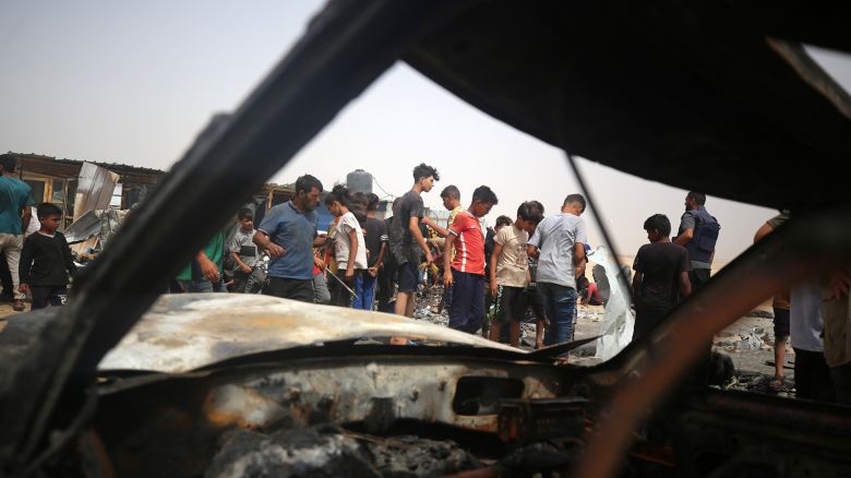 Palestinians are gathering at the site of an Israeli strike on a camp for internally displaced people in Rafah, on May 27, 2024, amid ongoing battles between Israel and the Palestinian Hamas militant group.
