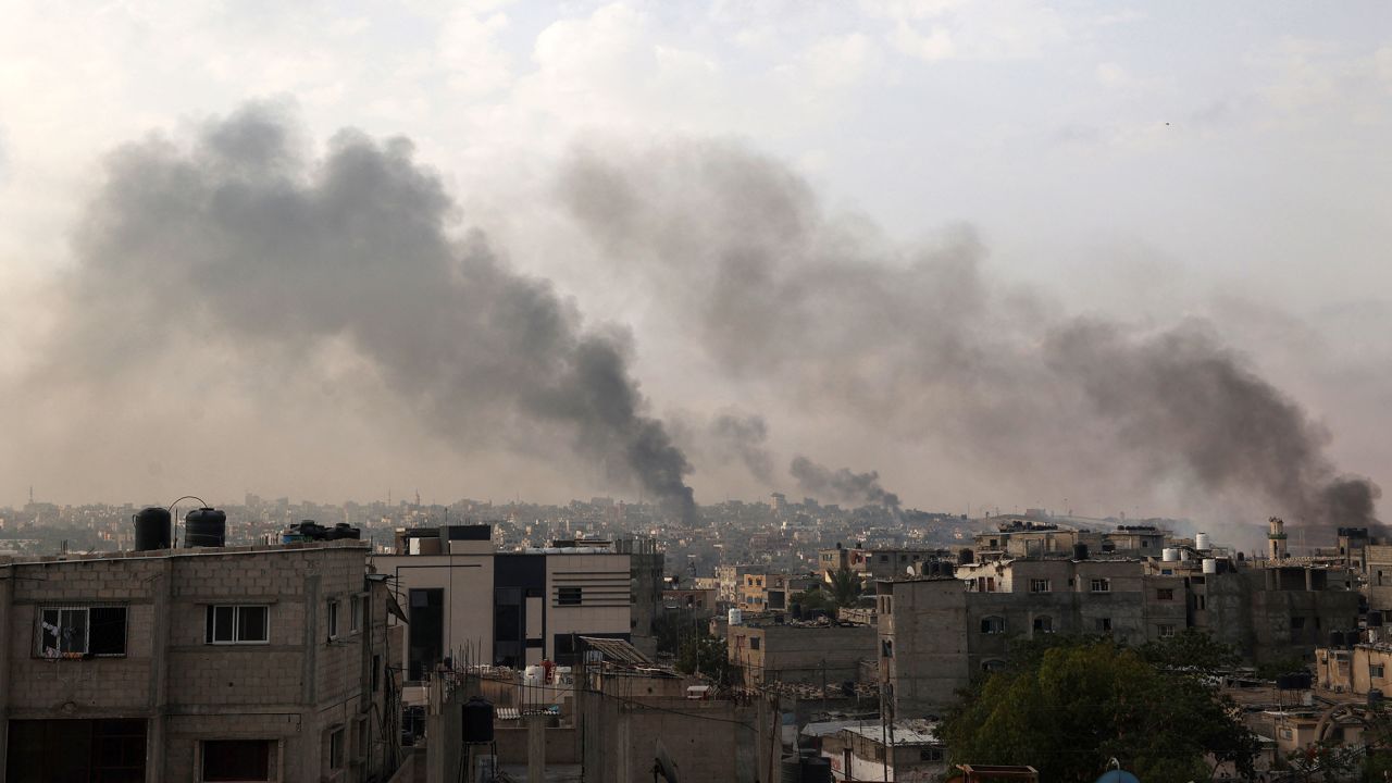 TOPSHOT - CORRECTION / Smoke billows following Israeli strikes in Rafah city in the southern Gaza Strip on May 28, 2024, amid the ongoing conflict between Israel and the Palestinian Hamas militant group. The UN Security Council was set to convene an emergency meeting on May 28 over an Israeli strike that killed dozens in a displaced persons camp in Rafah, as three European countries were slated to formally recognise a Palestinian state. (Photo by Eyad BABA / AFP) / "The erroneous LOCATION appearing in the metadata of this photo by Eyad BABA has been modified in AFP systems in the following manner: [Rafah - Palestinian Territories] instead of [Rafah - Egypt]. Please immediately remove the erroneous mention[s] from all your online services and delete it (them) from your servers. If you have been authorized by AFP to distribute it (them) to third parties, please ensure that the same actions are carried out by them. Failure to promptly comply with these instructions will entail liability on your part for any continued or post notification usage. Therefore we thank you very much for all your attention and prompt action. We are sorry for the inconvenience this notification may cause and remain at your disposal for any further information you may require." (Photo by EYAD BABA/AFP via Getty Images)