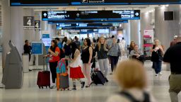Travelers make their way through the Miami International Airport on May 24, 2024, in Miami, Florida.