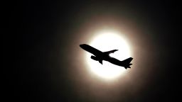 A commercial airliner passes in front of the sun in Boston, MA, on May 23.