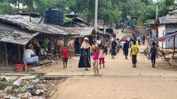 This photo taken on May 24, 2024 shows Rohingya refugees walking down a path at a Rohingya refugee camp in Ukhia in Bangladesh's southeastern Cox's Bazar district. Militant Rohingya groups in Bangladesh have forcibly recruited hundreds of young Rohingya men and boys to battle the Arakan Army, a rebel outfit in neighbouring Myanmar that has won a string of victories against the junta there. (Photo by AFP) / To go with 'BANGLADESH-MYANMAR-REFUGEE-CONFLICT-ROHINGYA, FOCUS' by Tanbirul Miraj RIPON with Shafiqul ALAM (Photo by -/AFP via Getty Images)