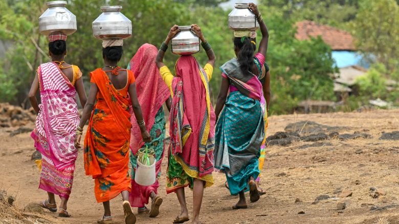 In this photo taken on May 26, 2024, villagers carry water pots in Shahapur district of India's Maharashtra state, amid ongoing heatwave. (Photo by Indranil MUKHERJEE / AFP) (Photo by INDRANIL MUKHERJEE/AFP via Getty Images)