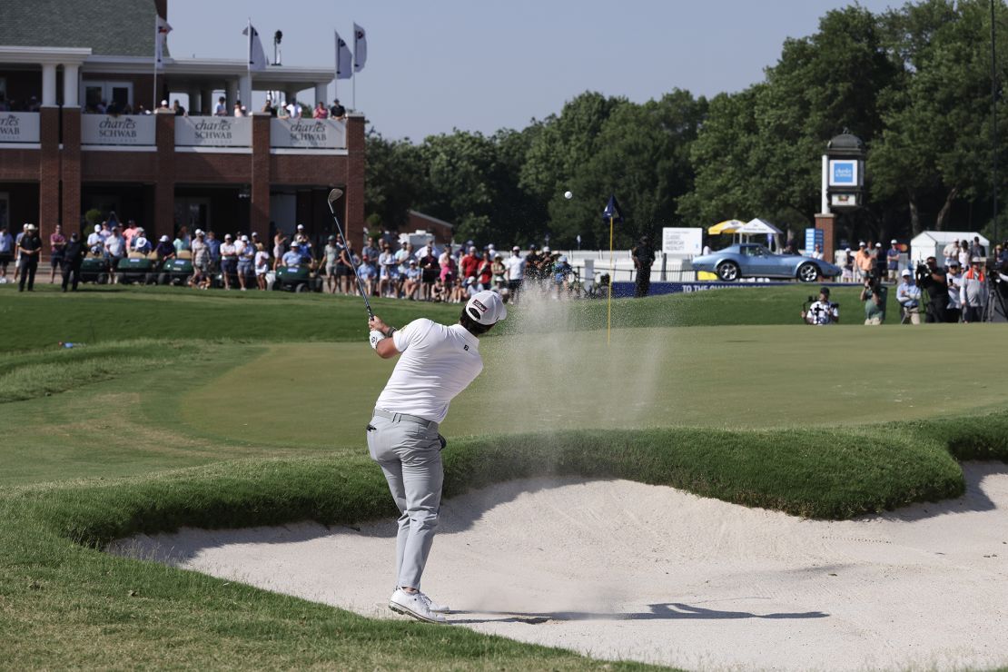 Riley plays a shot from a bunker on the 18th hole during the final round of the Charles Schwab Challenge.