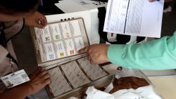 Officials from the National Electoral Institute (INE) prepare a package with electoral material that will be used in the upcoming presidential elections in an electoral district in Guadalajara, Jalisco state, Mexico, on May 31, 2024. Millions of Mexicans are expected to vote for their first woman president in a landmark election on June 2, 2024, following a long and sometimes acrimonious race overshadowed by soaring political violence. (Photo by ULISES RUIZ / AFP) (Photo by ULISES RUIZ/AFP via Getty Images)