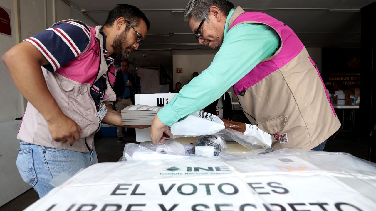 Officials from the National Electoral Institute (INE) prepare a package with electoral material that will be used in the upcoming presidential elections in an electoral district in Guadalajara, Jalisco state, Mexico, on May 31, 2024. Millions of Mexicans are expected to vote for their first woman president in a landmark election on June 2, 2024, following a long and sometimes acrimonious race overshadowed by soaring political violence. (Photo by ULISES RUIZ / AFP) (Photo by ULISES RUIZ/AFP via Getty Images)