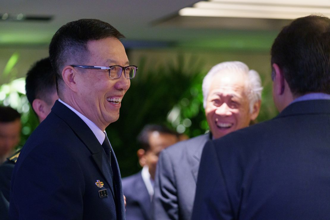 China's defense minister, Dong Jun (left) and  Singapore's defense minister, Ng Eng Hen (center) on the sidelines of the Shangri-La Dialogue in Singapore on June 1, 2024.