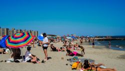 Beachgoers enjoy the sun on Rockaway Beach, in the Queens borough of New York, on June 1, 2024. (Photo by Charly TRIBALLEAU / AFP) (Photo by CHARLY TRIBALLEAU/AFP via Getty Images)