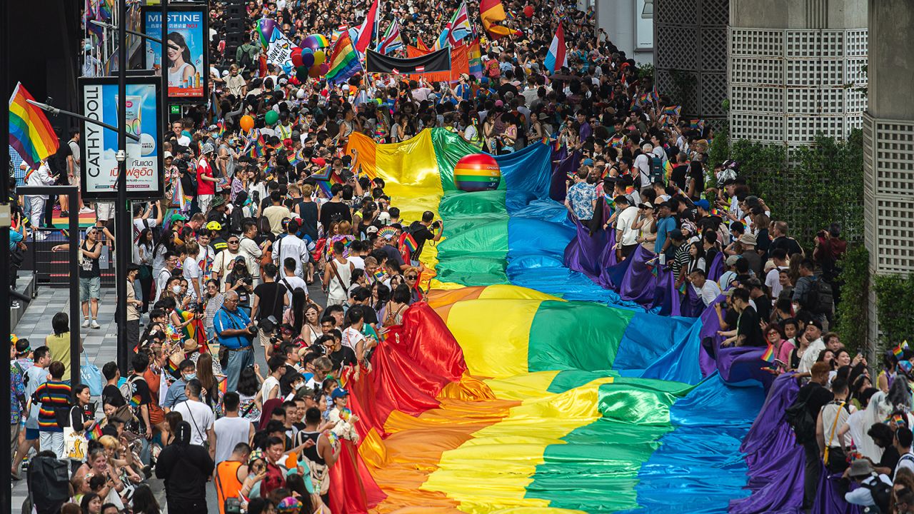 Participants march on Sukhumvit road while holding a rainbow flag during the Bangkok Pride Parade 2024, in Bangkok, Thailan on June 1, 2024.