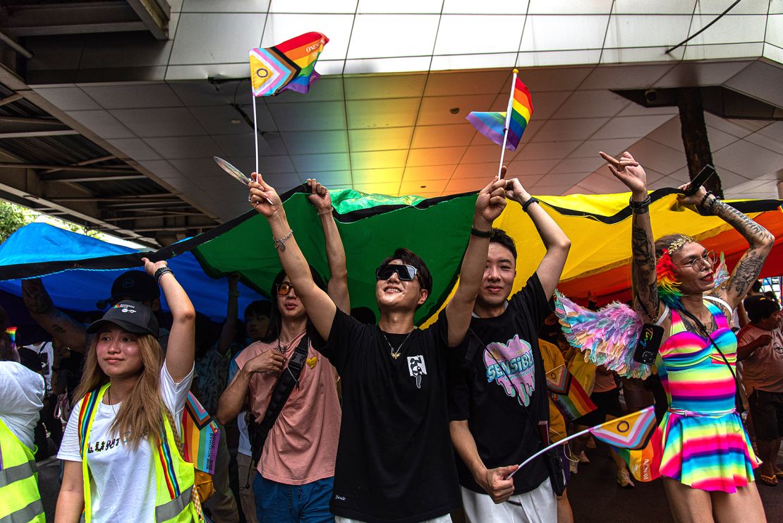 Participants march on Sukhumvit road while holding a rainbow flag during the Bangkok Pride Parade 2024, in Bangkok, Thailand, on June 1, 2024.