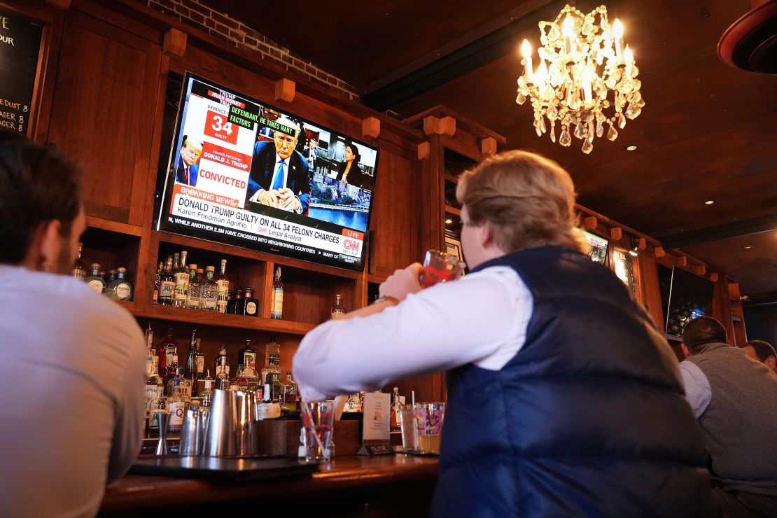 Patrons at the Hawk and Dove bar watch the news after former President Donald Trump was found guilty on all 34 counts in his criminal trial on May 30, in Washington, DC.