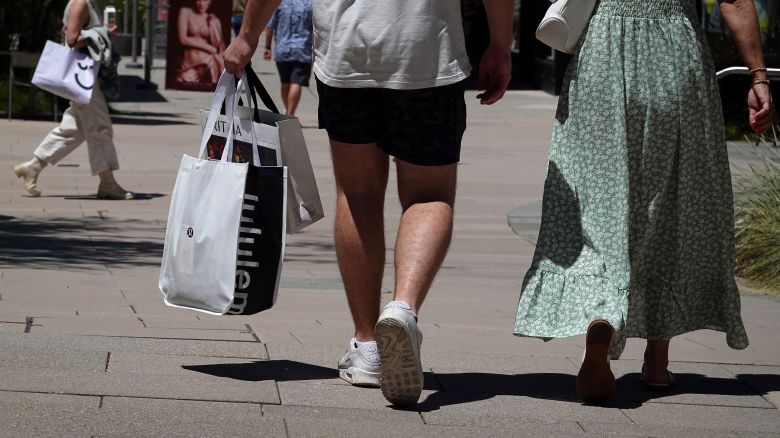 Shoppers carry shopping bags while walking through The Village at Corte Madera on May 30, 2024, in Corte Madera, California. Economists expected US consumer spending to grow at a slower pace in April than it did in March.