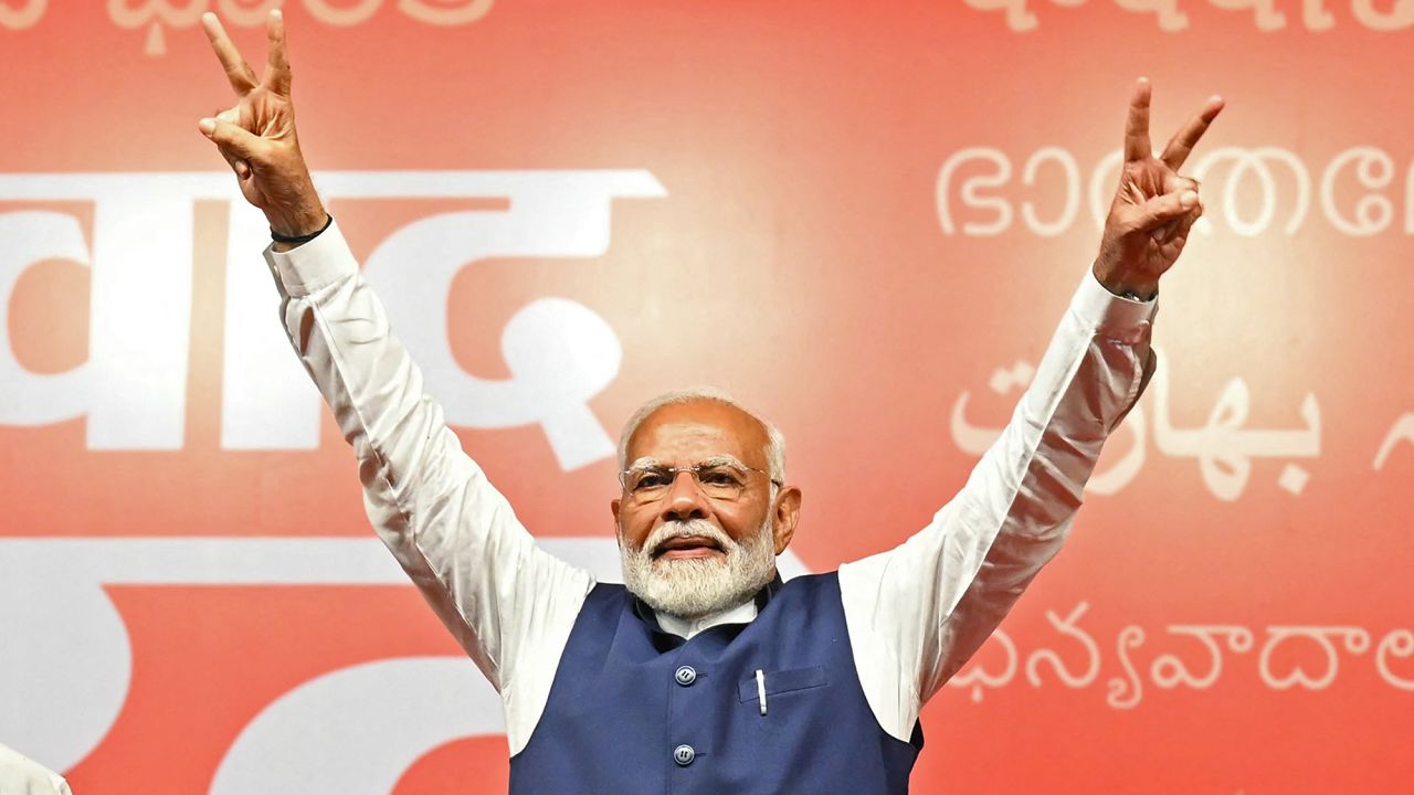 India's Prime Minister Narendra Modi flashes victory sign at the Bharatiya Janata Party (BJP) headquarters to celebrate the party's win in country's general election, in New Delhi on June 4, 2024. Modi claimed election victory for his party and its allies on June 4, but the opposition said they had "punished" the ruling party to confound predictions and reduce their parliamentary majority. (Photo by Money SHARMA / AFP) (Photo by MONEY SHARMA/AFP via Getty Images)