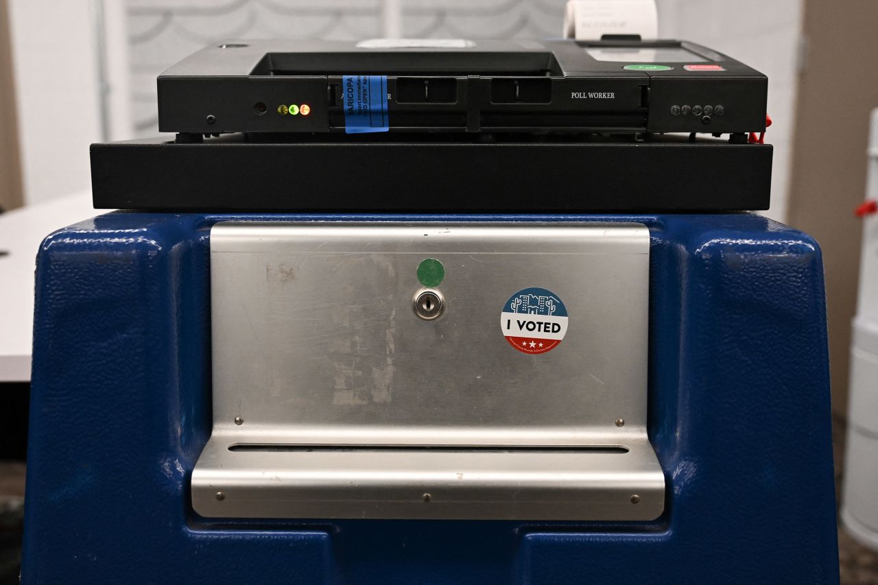 An "I Voted" sticker is displayed on a ballot lock box beneath a Dominion Voting Machines tabulator at in Phoenix, Arizona, on June 3.