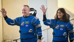 NASA astronauts  Butch Wilmore (L) and Suni Williams, wearing Boeing spacesuits, wave as they prepare to depart the Neil A. Armstrong Operations and Checkout Building at Kennedy Space Center for Launch Complex 41 at Cape Canaveral Space Force Station in Florida to board the Boeing CST-100 Starliner spacecraft for the Crew Flight Test launch, on June 5, 2024. Boeing on June 5 will try once more to launch astronauts aboard a Starliner capsule bound for the International Space Station. Liftoff is targeted for 10:52 am (1452 GMT) for a roughly one-week stay at the orbital laboratory. (Photo by Miguel J. Rodriguez Carrillo / AFP) (Photo by MIGUEL J. RODRIGUEZ CARRILLO/AFP via Getty Images)