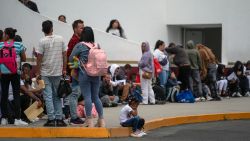 Asylum seekers queue at the El Chaparral crossing port to attend their appointment with US authorities at the US-Mexico border in Tijuana, Baja California State, Mexico, on June 5, 2024. President Joe Biden said Tuesday he had ordered sweeping new migrant curbs to "gain control" of the US-Mexico border, making a dramatic bid to neutralize one of his political weak spots in his reelection battle against Donald Trump. (Photo by Guillermo Arias / AFP) (Photo by GUILLERMO ARIAS/AFP via Getty Images)