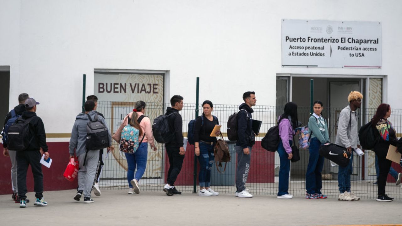 Asylum seekers queue at the El Chaparral crossing port to attend their appointment with US authorities at the US-Mexico border in Tijuana, Baja California State, Mexico, on June 5, 2024. President Joe Biden said Tuesday he had ordered sweeping new migrant curbs to "gain control" of the US-Mexico border, making a dramatic bid to neutralize one of his political weak spots in his reelection battle against Donald Trump. (Photo by Guillermo Arias / AFP) (Photo by GUILLERMO ARIAS/AFP via Getty Images)