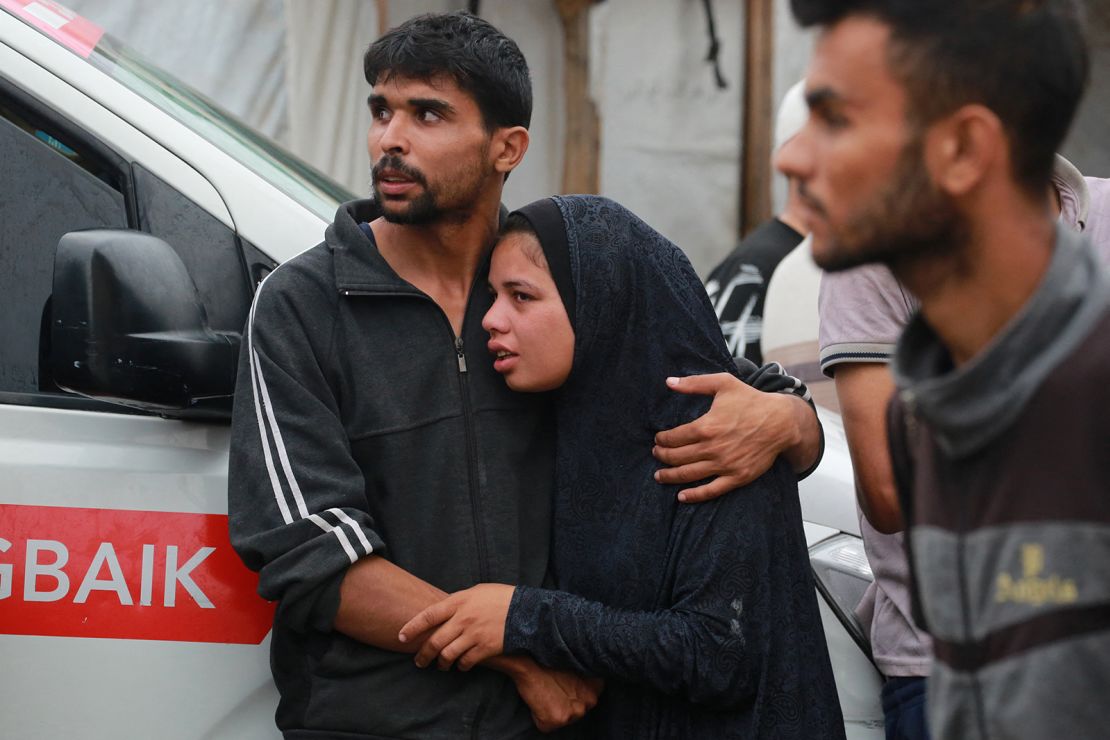 Palestinians gather outside a UN-run school after it was hit by an Israeli airstrike on June 6, 2024.