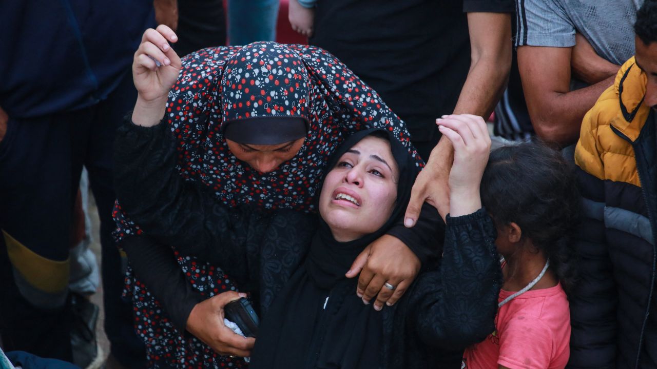 EDITORS NOTE: Graphic content / Relatives mourn over the body of a man killed in an Israeli airstrike at a UN school housing displaced Palestinians in Nuseirat, at a hospital ground in Deir el-Balah, on June 6, 2024, amid the ongoing conflict between Israel and the Hamas militant group. A hospital in Gaza said on June 6 the death toll from an Israeli air strike on a UN school which the military said housed a "Hamas compound" had risen to 37. (Photo by Bashar TALEB / AFP) (Photo by BASHAR TALEB/AFP via Getty Images)