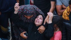 EDITORS NOTE: Graphic content / Relatives mourn over the body of a man killed in an Israeli airstrike at a UN school housing displaced Palestinians in Nuseirat, at a hospital ground in Deir el-Balah, on June 6, 2024, amid the ongoing conflict between Israel and the Hamas militant group. A hospital in Gaza said on June 6 the death toll from an Israeli air strike on a UN school which the military said housed a "Hamas compound" had risen to 37. (Photo by Bashar TALEB / AFP) (Photo by BASHAR TALEB/AFP via Getty Images)