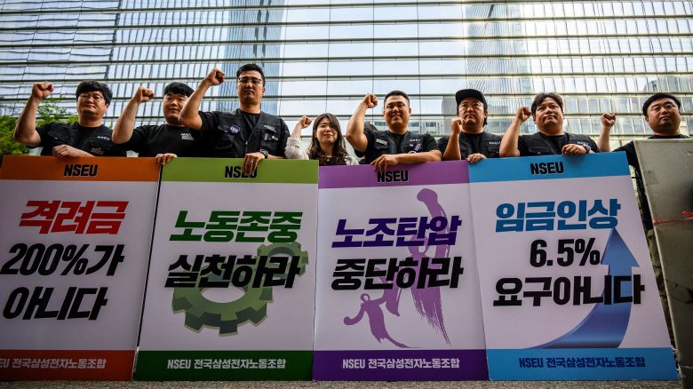 Samsung Electronics' union members hold placards during a rally outside the company building in Seoul on June 7, 2024, as workers at the tech giant staged the first ever strike.