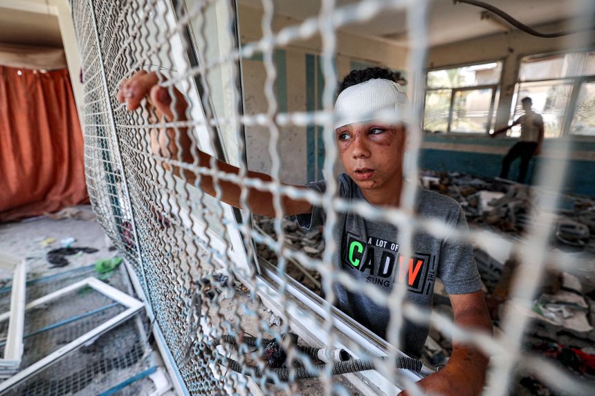 A Palestinian boy stands in the rubble of a destroyed school-turned-shelter in Nuseirat, central Gaza, on June 7, 2024. Rights workers warn children are bearing the brunt of the Israeli offensive.