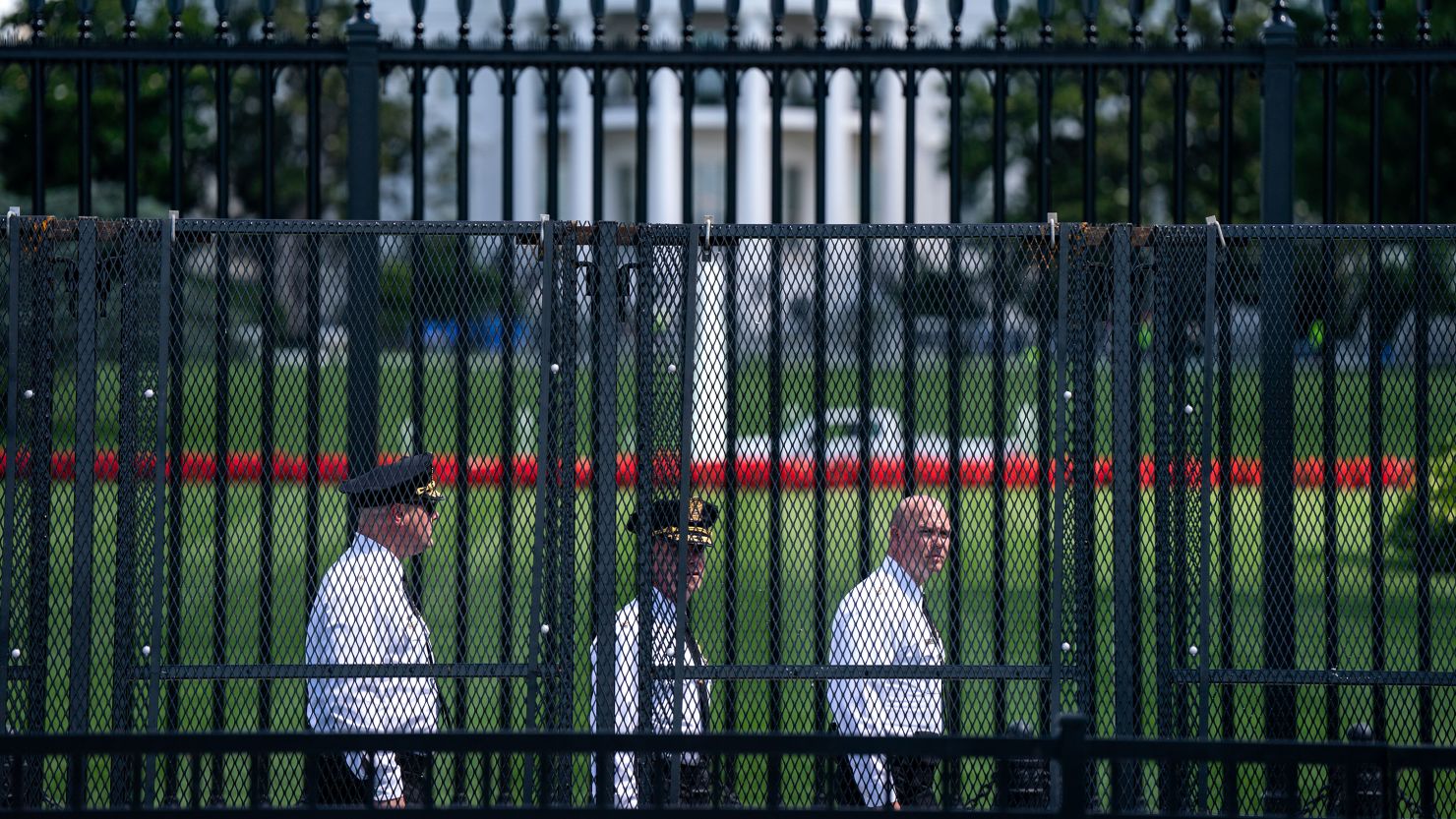 WASHINGTON, DC - JUNE 7: Law enforcement officials walk around the security fencing set around the White House complex on June 7, 2024 in Washington, DC. The fencing was installed in anticipation of a weekend pro-Palestinian protest where activists have called for demonstrators to surround the White House. (Photo by Kent Nishimura/Getty Images)