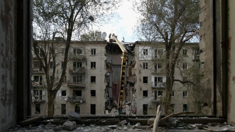 Rescuers clear the rubble of a destroyed residential building following a missile attack in Luhansk.