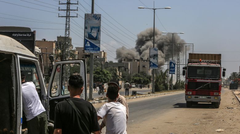 Palestinians watch smoke rising from the residential area following the Israeli attacks on Deir al-Balah, Gaza on June 08, 2024.