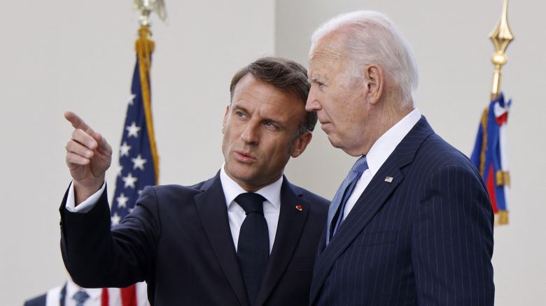 France's President Emmanuel Macron (L) talks with US President Joe Biden during a ceremony at the Arc of Triomphe, in Paris, on June 8, 2024.