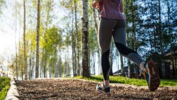Woman jogging along the path at the public park