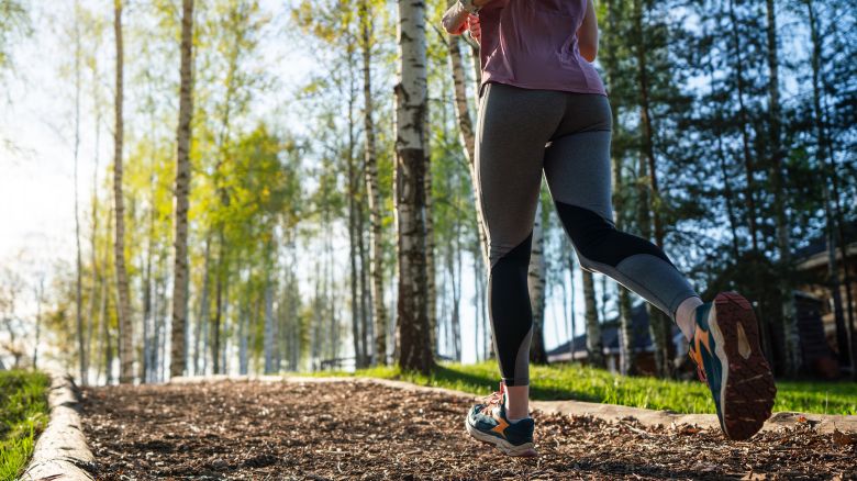 Woman jogging along the path at the public park