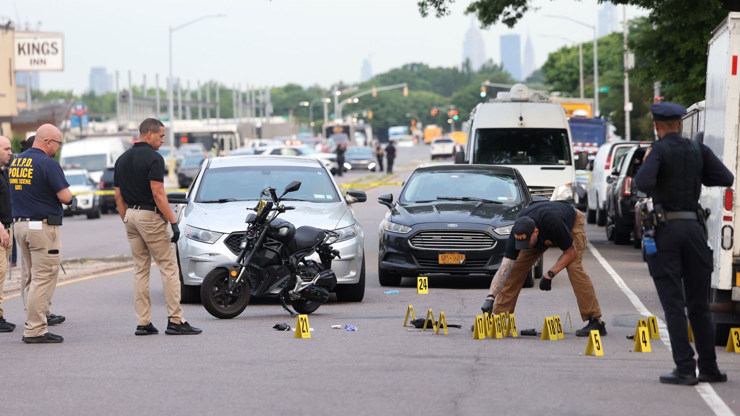 Investigators at scene where NYPD officers exchanged gunfire with a 19-year-old assailant in Queens on Monday.