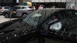 A man inspects an electric car at a showroom in Riyadh on June 8, 2024. Although the EV market in the world's largest oil exporter remains small compared with the United States and China, it tripled last year to nearly 800 cars, according to Saudi business news outlet Al-Iqtisadiyah.