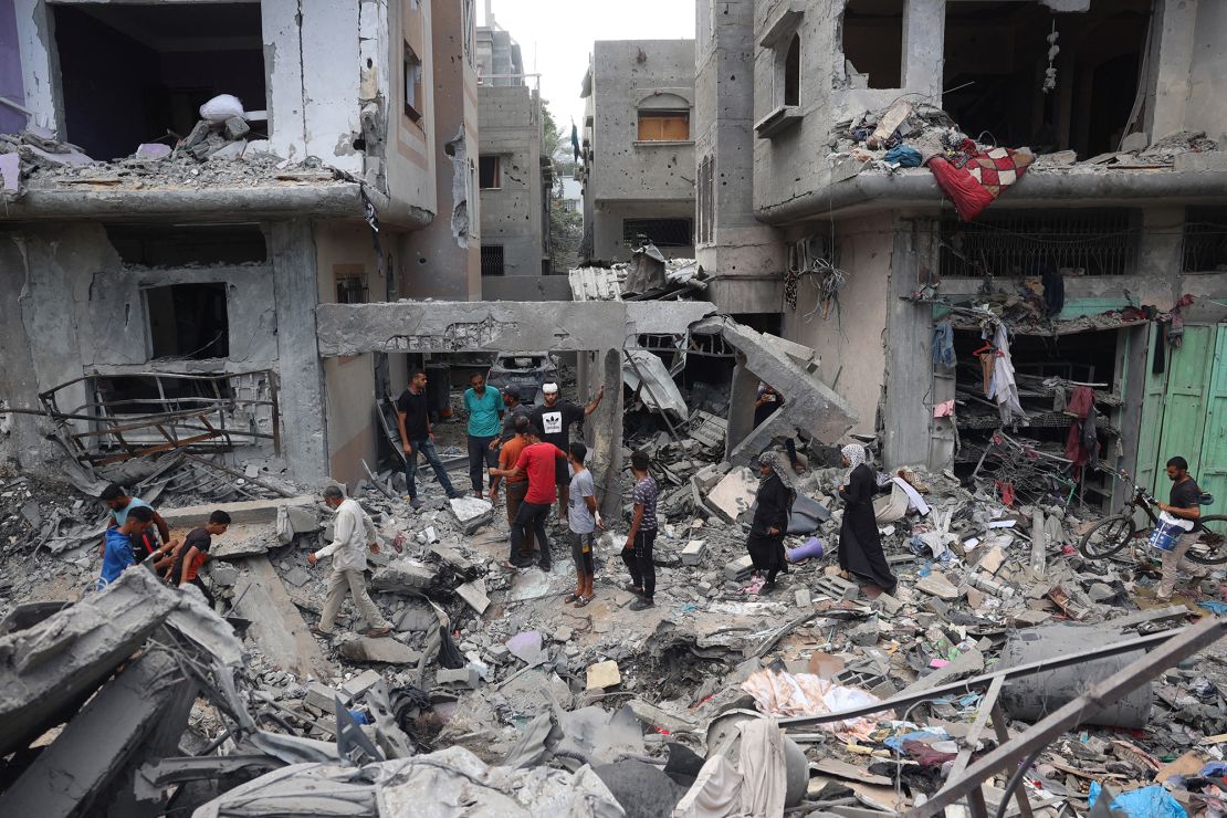 Palestinians inspect damage after an Israeli strike on the Nuseirat camp in central Gaza, June 9, 2024.