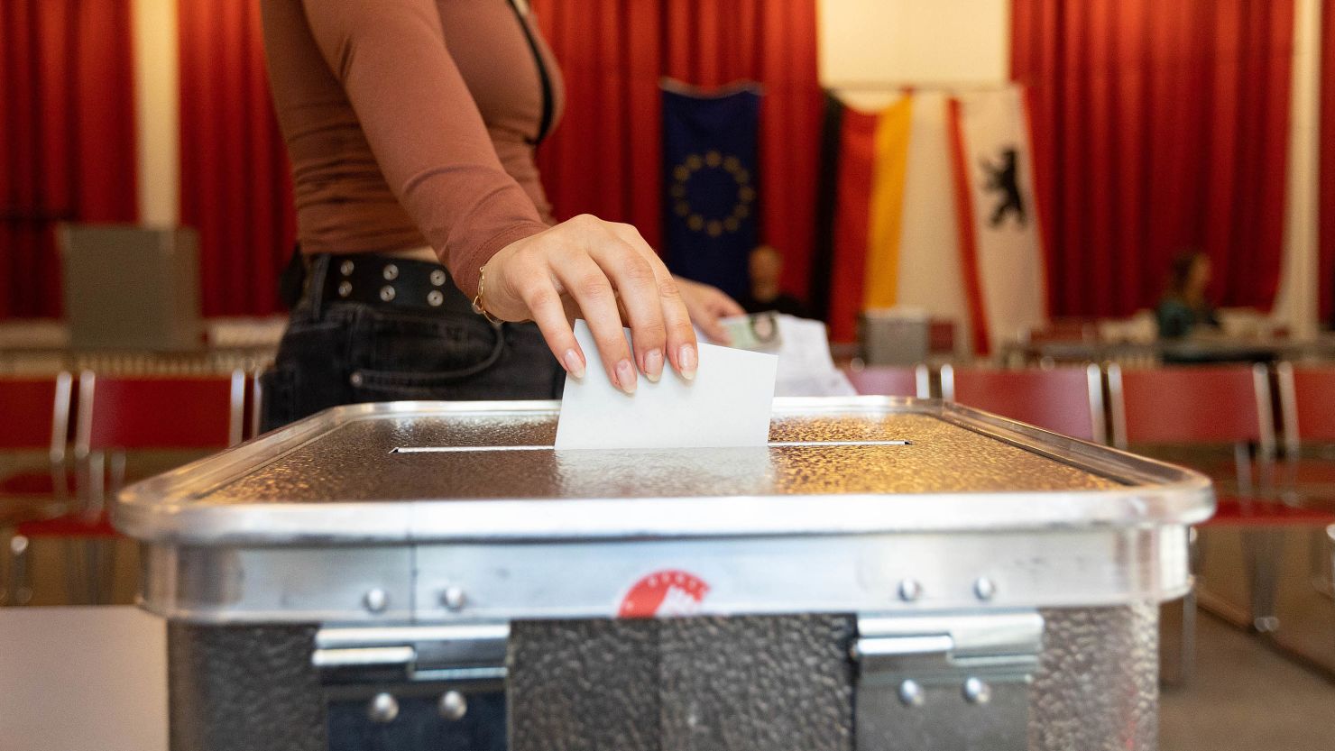 A voter casts her ballot at a polling station during the European Parliamentary election, in Berlin, on June 9, 2024.