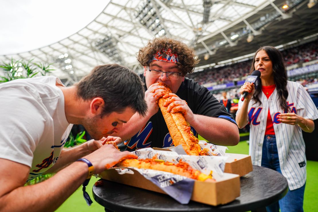 Two fans participate in an eating contest during the 2024 London Series.